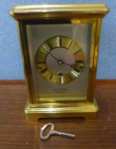 A Rapport of London brass and four sided glass mantel clock