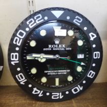 A Rolex style dealer's display wall clock