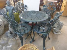 A painted cast alloy garden table and four chairs