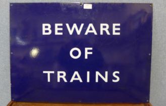 A blue enamelled metal Beware of Trains sign