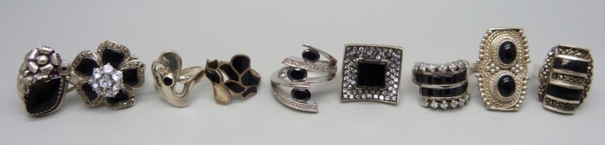 Nine large chunky silver and white metal black stone set rings, mostly onyx, up to 32mm, 96g, six