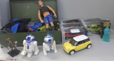 An Action Man figure with a collection of clothes and accessories and a collection of model cars (