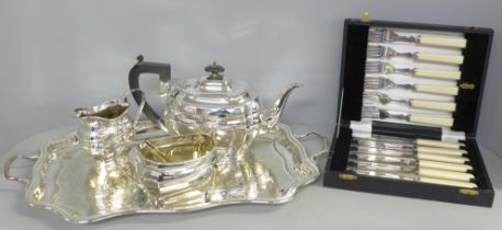 A silver plated tea set on a gallery tray and a boxed set of EPNS fish knives and forks