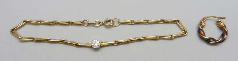 An 18ct gold and white stone bracelet, 20.5cm, 7.1g, and a 9ct gold earring, 0.5g