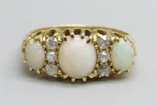An 18ct gold three stone opal and diamond ring, 3.2g, M
