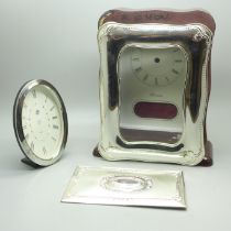 A silver fronted clock case, (no movement), one other case and a plaque