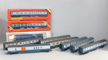 A collection of model rail including eight blue/grey coaches, and a blue diesel Intercity locomotive