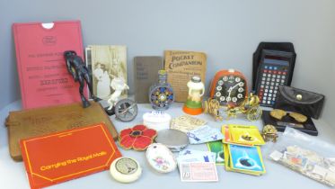 A collection of assorted items including stamps, Pokemon cards, a clock, etc.