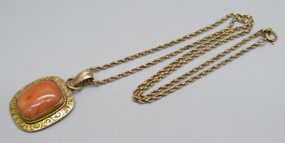 A gilt metal framed stone set pendant on a rope chain with 9ct plaque, chain 5.9g, repaired, 48cm