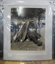 Social history; 16 x 20" photograph of Hyde Park attendant asleep under a stack of deck chairs,