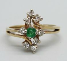 A yellow metal ring marked 10-14k, set with an emerald and eight diamonds, signed Bermark, 2.4g, M
