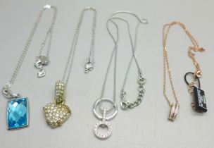 Four Swarovski pendants and chains