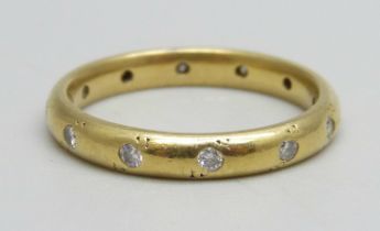 An 18ct gold wedding band set with 12 diamonds, 3.9g, N