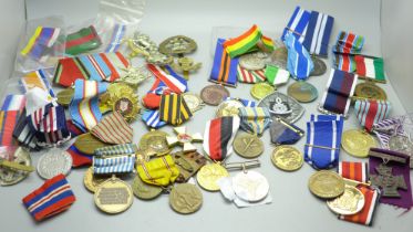 A collection of medals including German, Soviet Union, cap badges and ribbons, (including some