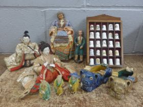 Two oriental dolls, other dolls, oriental figures, two ashtrays, a/f, thimbles and a collection of