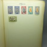 An album of world postage stamps, sorted in alphabetical order, Abbysinia to Venezuela, including