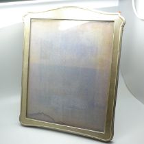 A silver photograph frame with oak panel back and stand, Birmingham 1916, height 30cm