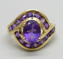 An 18ct gold, and amethyst set crossover ring, 5.1g, M/N