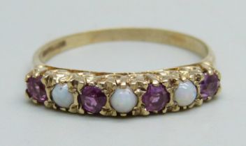 A 9ct gold ring set with three opals and four rubies, 2.5g, Q
