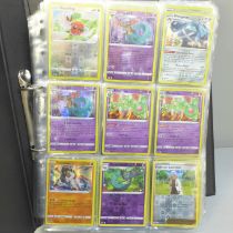 A folder of approximately 300+ holographic Pokemon cards