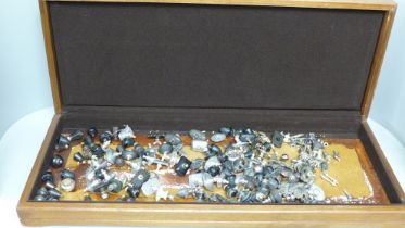 A large wooden box containing over 110 various knobs and screws to fit teapots, coffee pots, dishes,