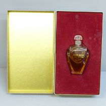 A bottle of Magie Noire Lancôme perfume, boxed