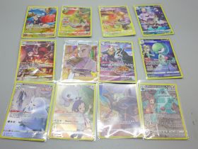 Twelve full artwork holographic Pokemon cards