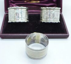 A pair of silver napkin rings and one other silver napkin ring, 67g
