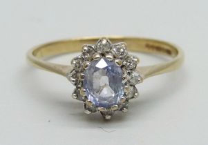 A 9ct gold cluster ring set with a light purple stone and small diamonds, 1.4g, L