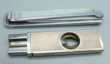 A silver cigar cutter, a/f, and a silver pipe smokers tool