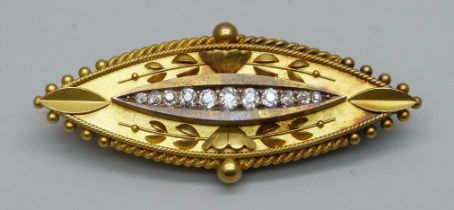 A 15ct gold brooch set with 11 diamonds, 8.1g, 4.5cm