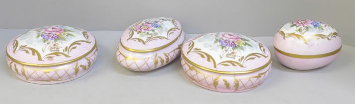 A Limoges four piece dressing table set decorated with flowers against a pink ground **PLEASE NOTE