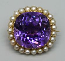 A 15ct gold brooch set with a cushion cut amethyst and seed pearl border, 11.7g, amethyst