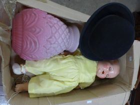 A pink glass light shade, a bowler hat and a doll