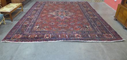 An Iranian red ground rug, 395 x 325cms