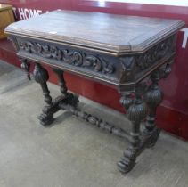 A 19th Century French carved oak fold-over games table