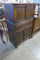 A carved oak linenfold cocktail cabinet