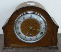 An oak mantel clock and a walnut aneroid barometer