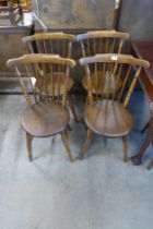 A set of four Victorian elm and beech penny seat kitchen chairs