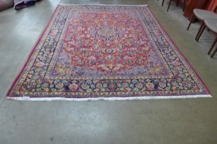 An Iranian red ground rug, 332 x 253cms