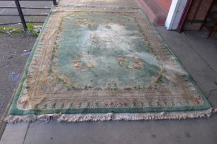 A large Chinese green ground rug and one other