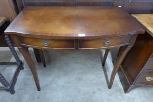 A Regency style mahogany bow front two drawer side table