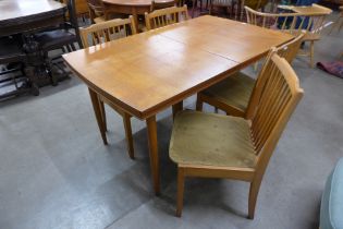 A teak rectangular extending dining table and four chairs