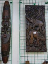 An African carved wooden wall mask and a carved elephant plaque