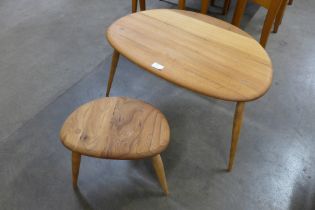 An Ercol elm and beech pebble shaped nest of two tables