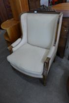 An early 20th Century French carved walnut and fabric upholstered fauteuil chair