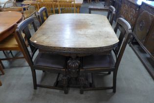 An early 20th Century carved oak six piece dining suite