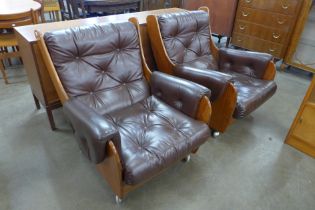 A pair of G-Plan teak and burgundy leather Saddle armchairs. Please note this lot is being sold as a