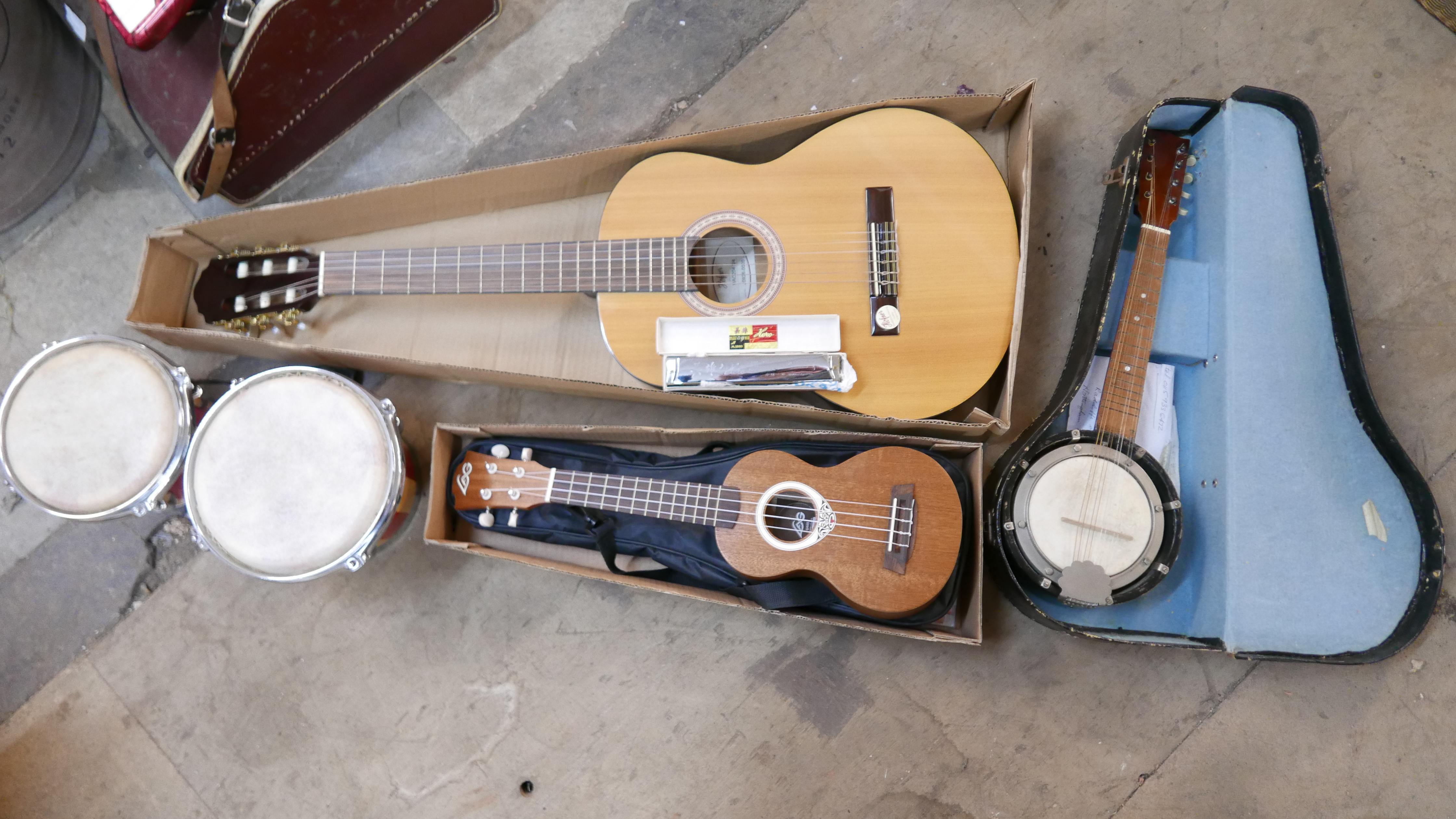 A Hofner guitar, a ukulele, pair of bongo drums, a banjo and a Haro harmonica