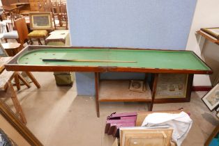 A bagatelle board, games table and cue